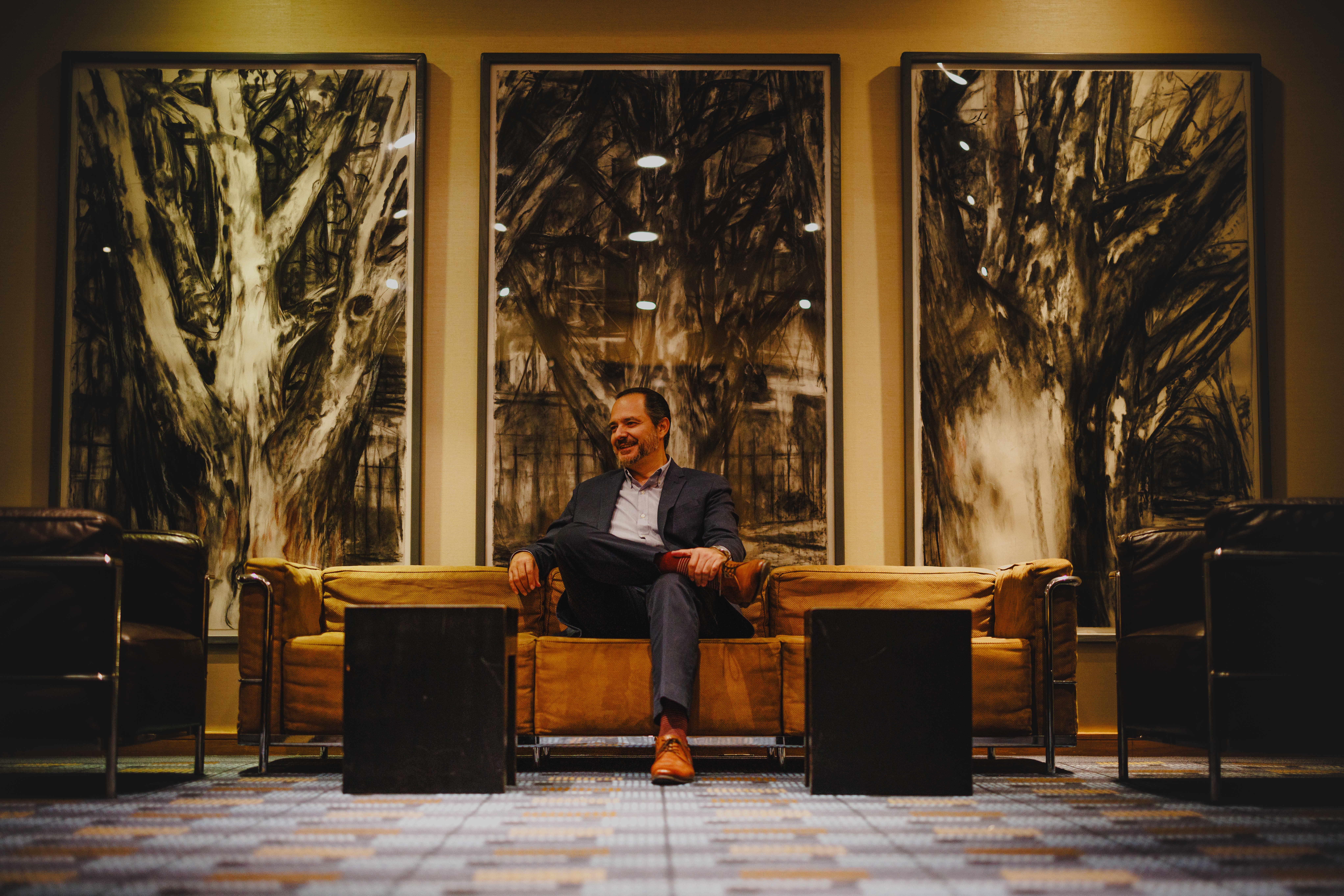 Jose Gutierrez, Broker, in an upscale office setting